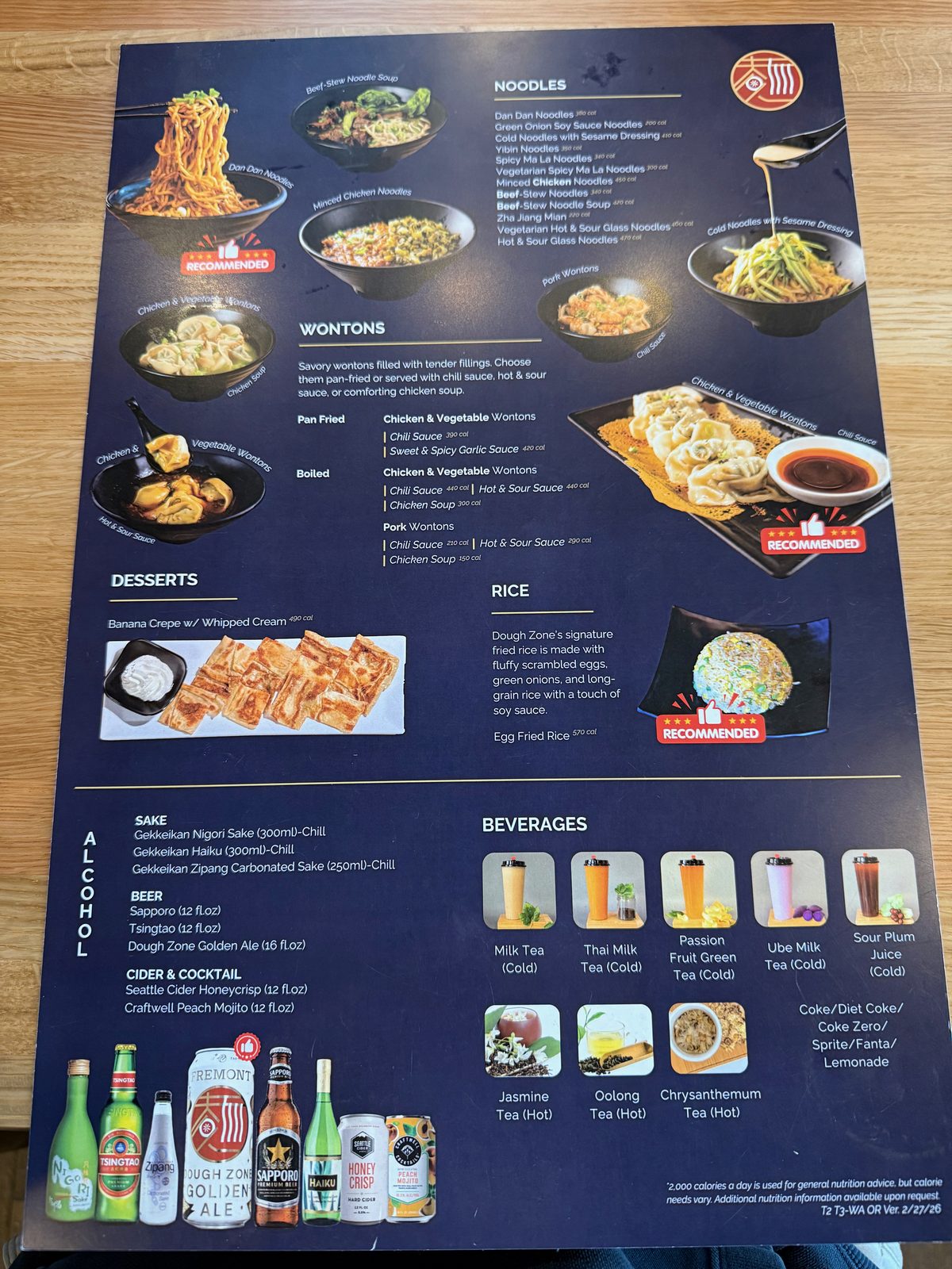 The second page of the Dough Zone menu, showing Dan Dan noodles, wontons, desserts, fried rice, and a beverage list of milk teas